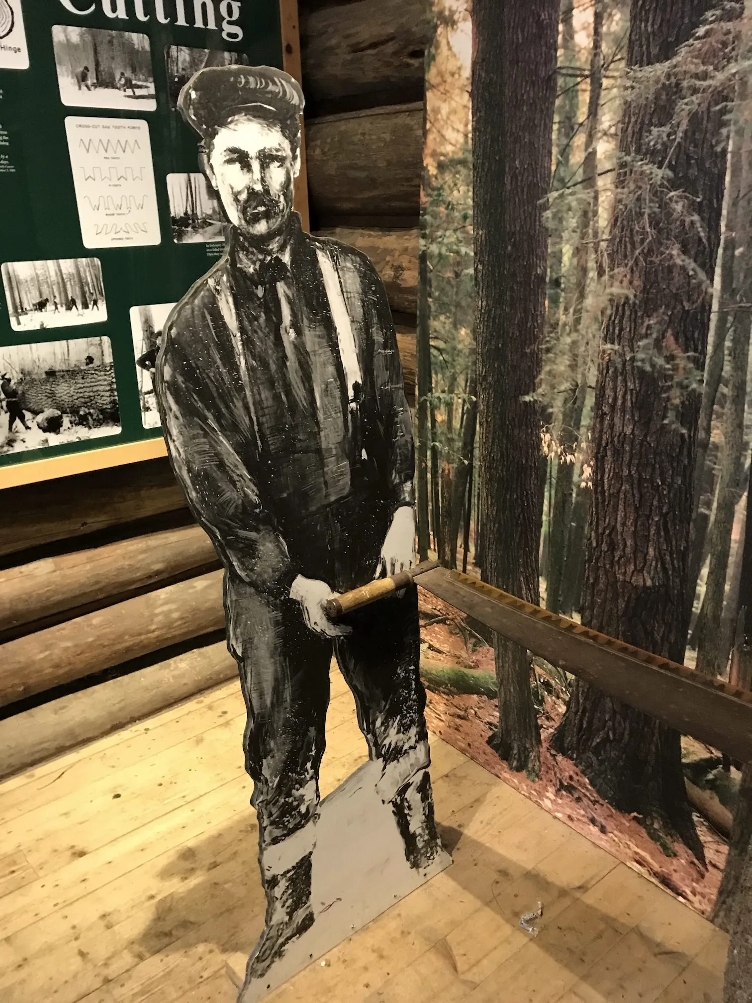 Cardboard man with large saw, part of a logging museum
