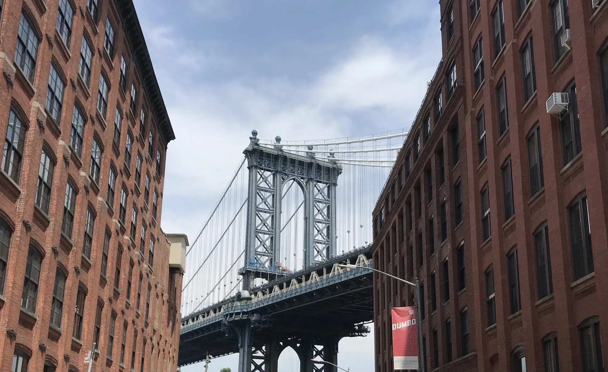 The Brooklyn bridge viewed from that street in Dumbo where the tourists gather
